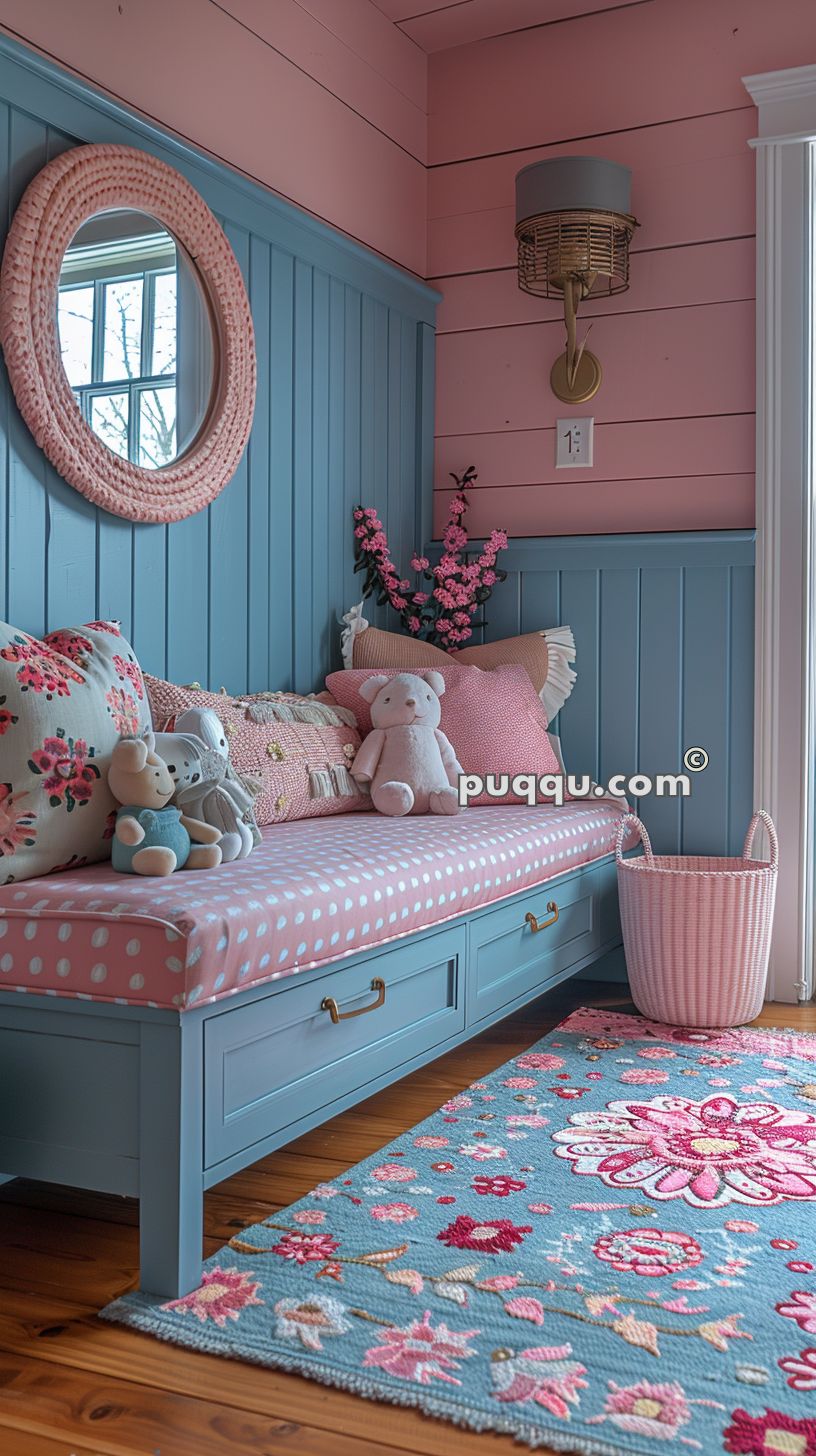 Cozy children's room with a blue bench, pink polka-dotted cushion, plush toys, floral pillows, a round mirror with a pink frame, a wicker wall lamp, pink flowers, and a blue floral rug.