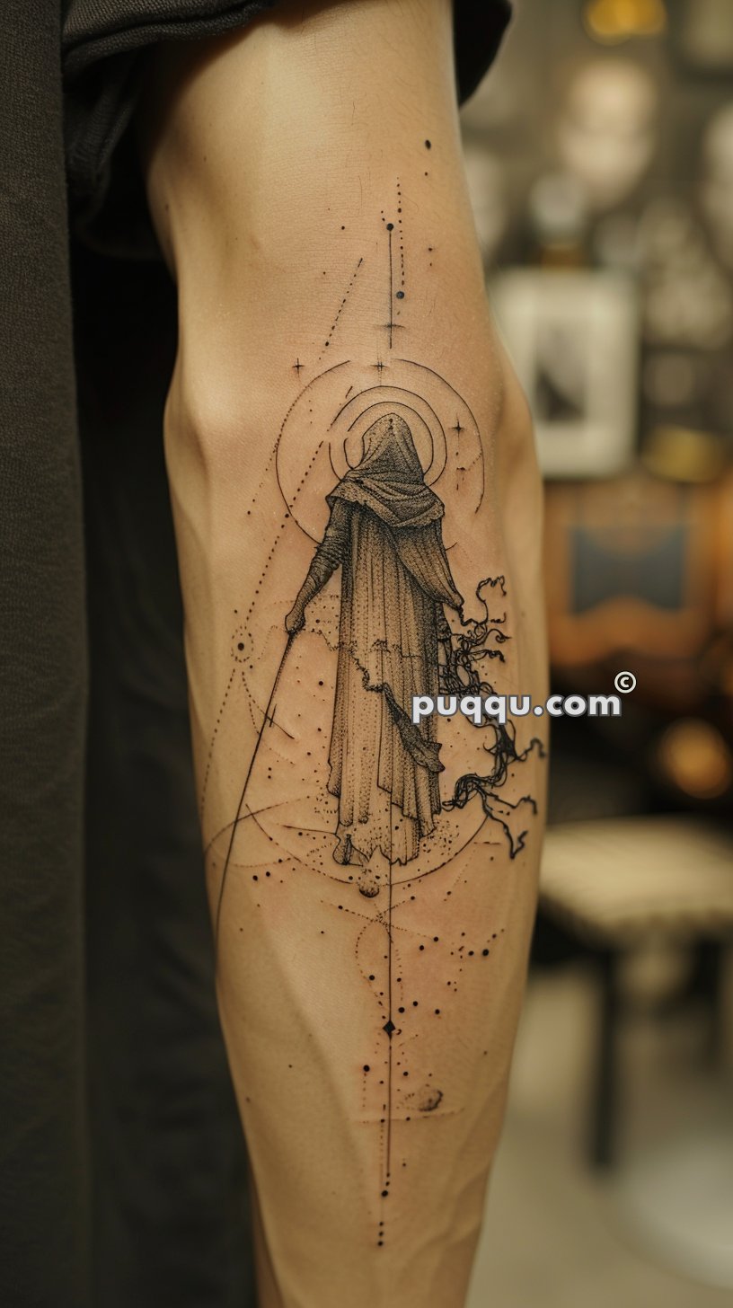 Tattoo of a robed and hooded figure holding a staff, surrounded by abstract lines and dots, on a person's inner arm.