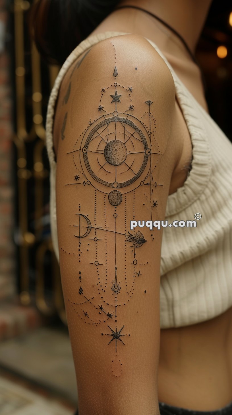 Close-up of a woman's upper arm with an intricate geometric and celestial-themed tattoo.