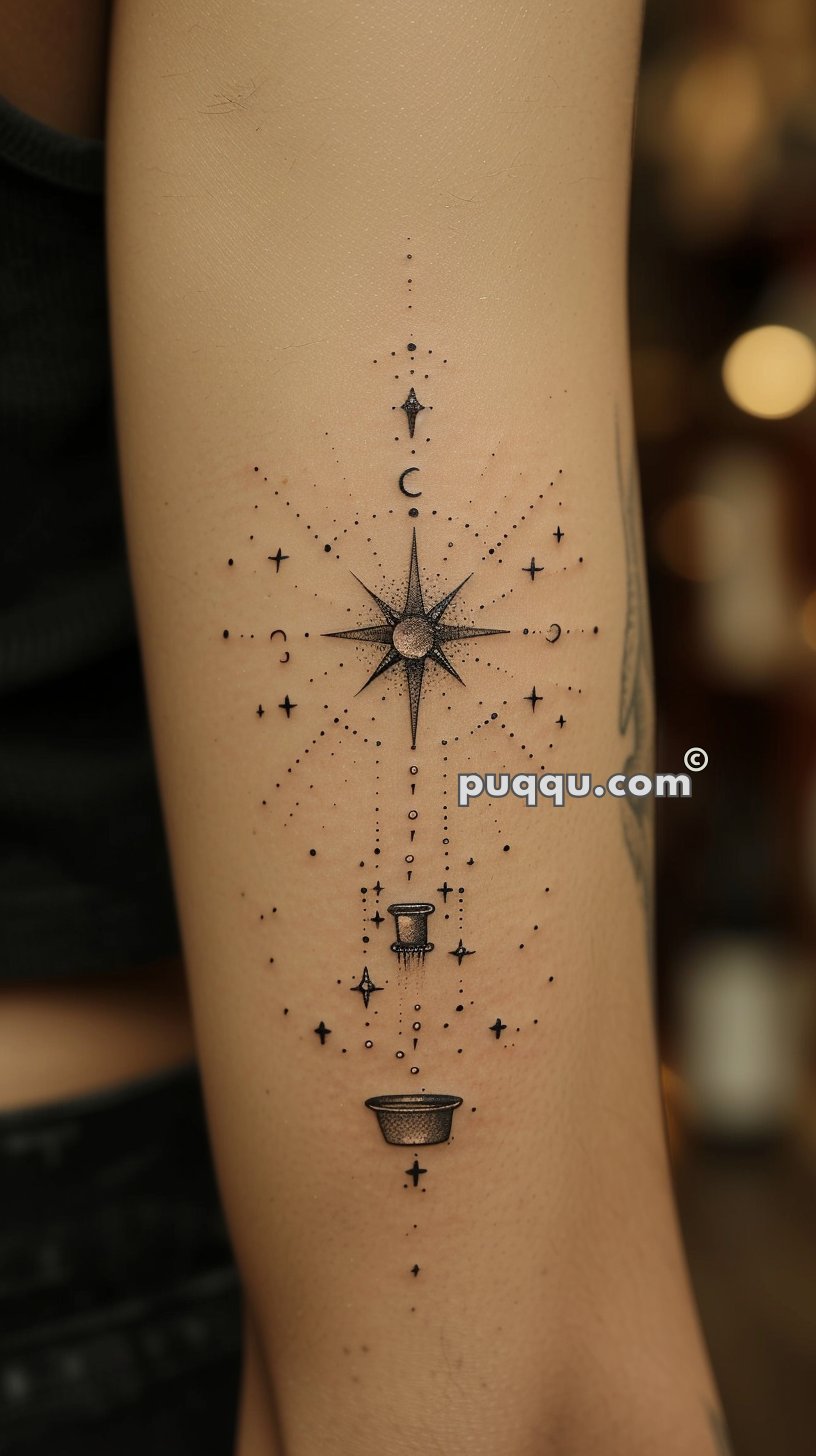 Tattoo of a detailed star surrounded by crescent moons, dots, and smaller stars, with an abstract design of a top hat and bowl at the bottom.