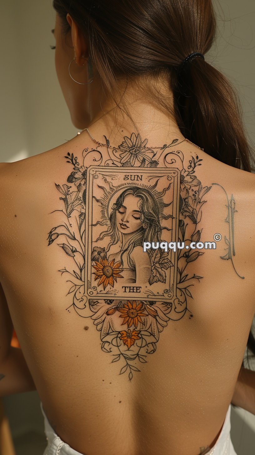 A woman with a large back tattoo of a tarot card design featuring "The Sun" card, which depicts a serene woman surrounded by floral and decorative elements.