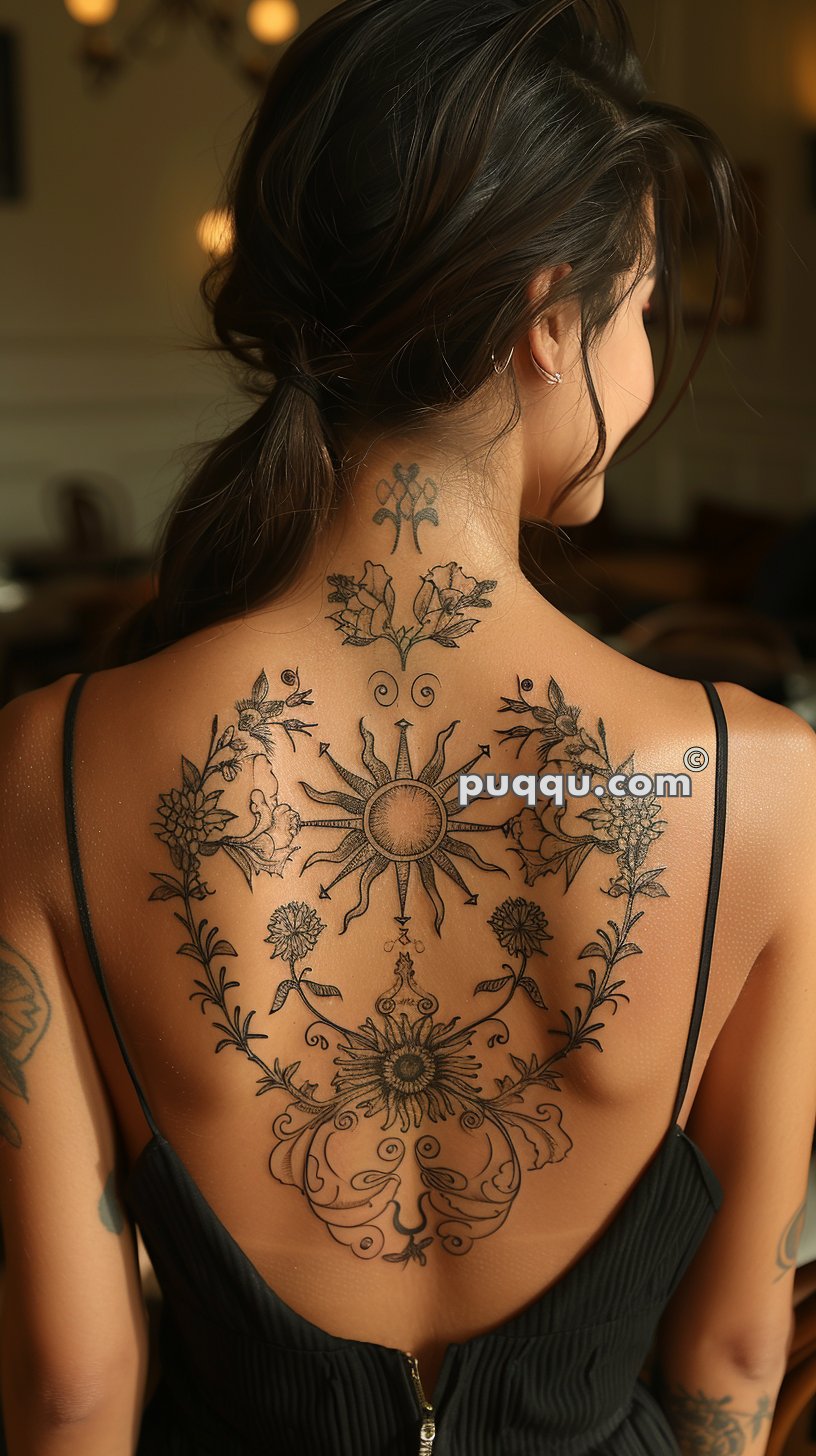 Woman with intricate flower and sun-themed tattoos on her back, wearing a black, backless dress.