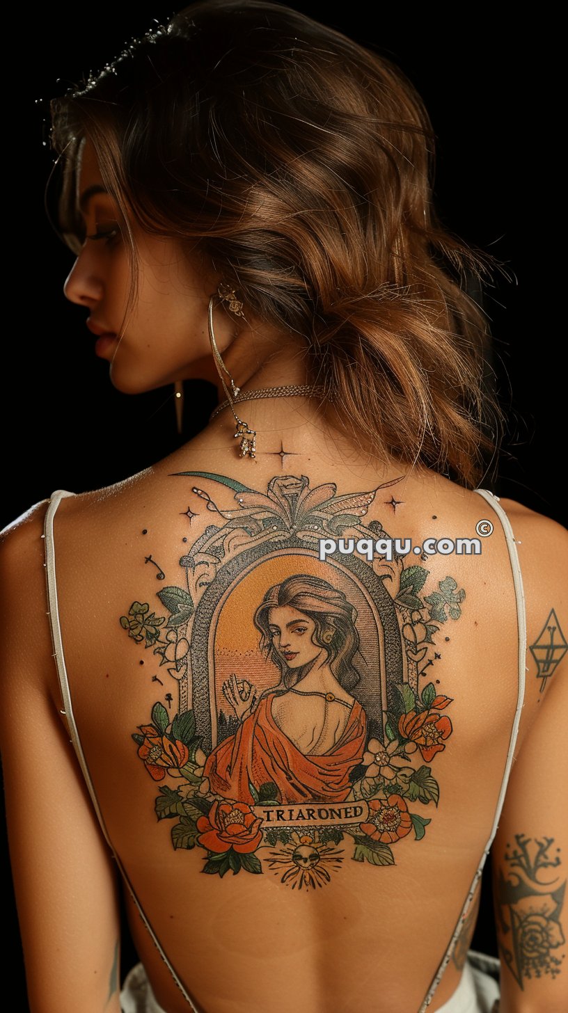 Woman with long wavy hair showing a detailed tattoo on her back, featuring an ornate frame surrounding a portrait of a woman in an orange robe, with flowers and the text "TRIARONED" below.