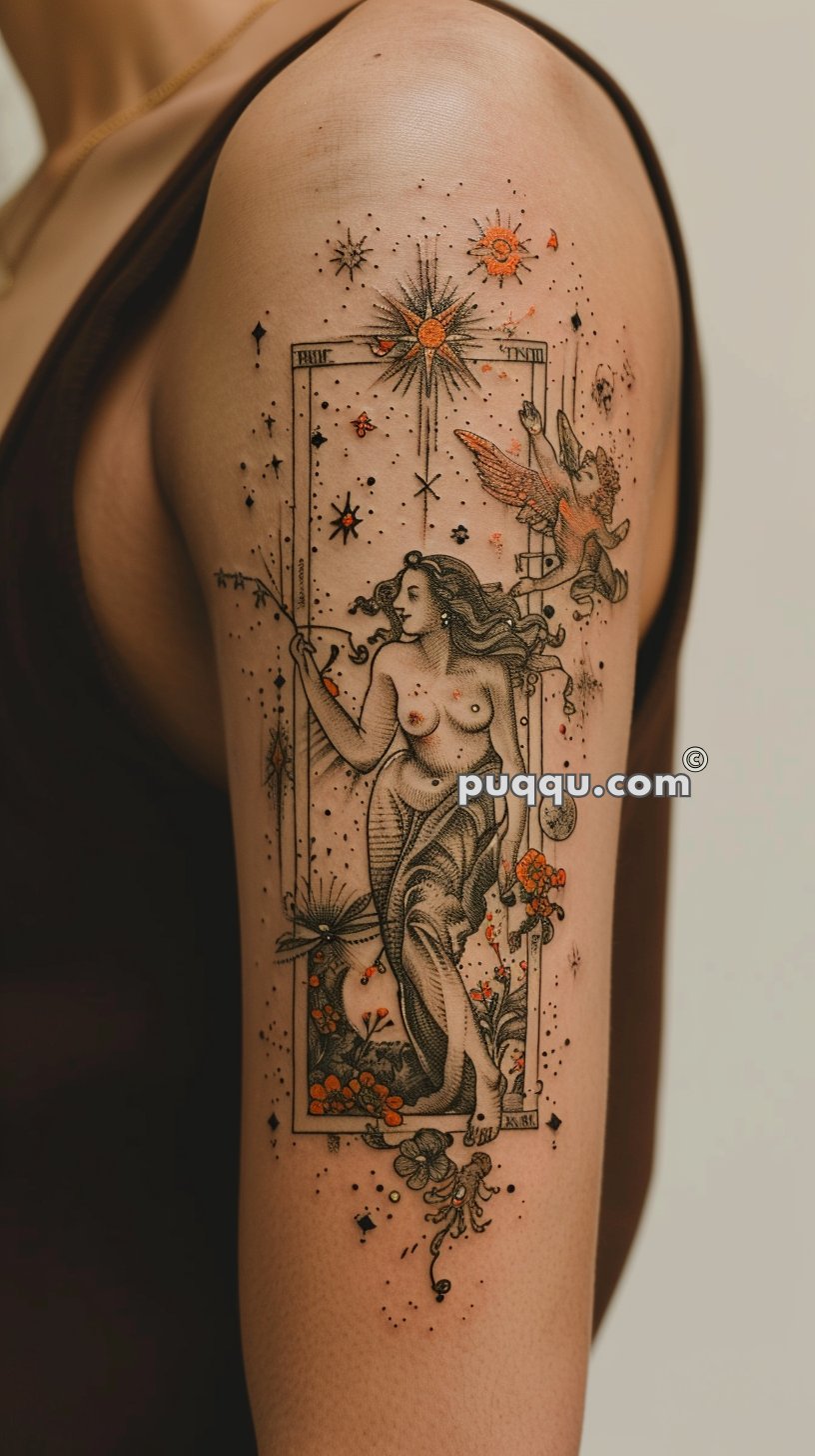 Ornate tattoo on upper arm depicting a classical-style woman in flowing garments pointing upwards, encased in an elaborate frame with birds, stars, and flowers.