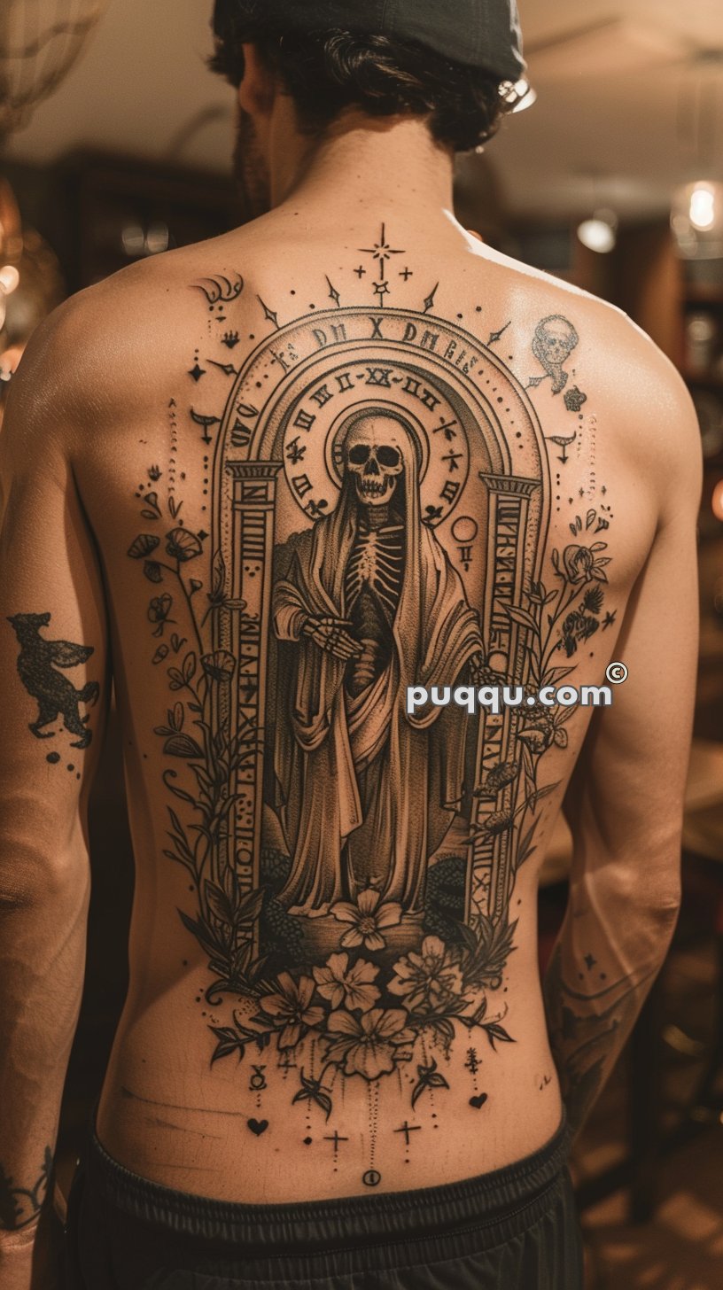 A person with a detailed full-back tattoo depicting a cloaked skeleton holding a scythe, framed by floral and celestial designs.