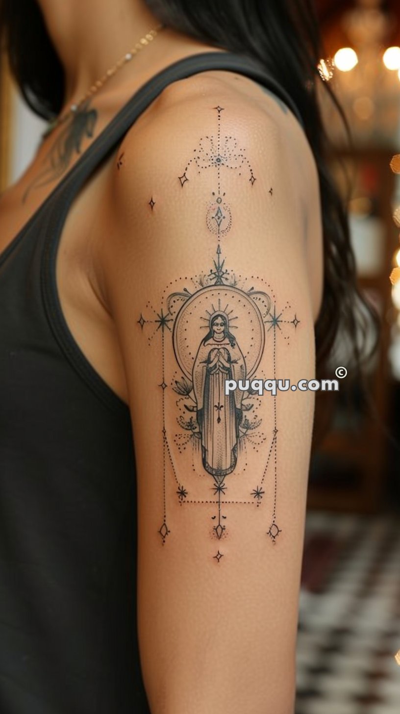 A detailed line-art tattoo on an upper arm depicting a saintly figure with a halo, surrounded by intricate dot and star patterns.