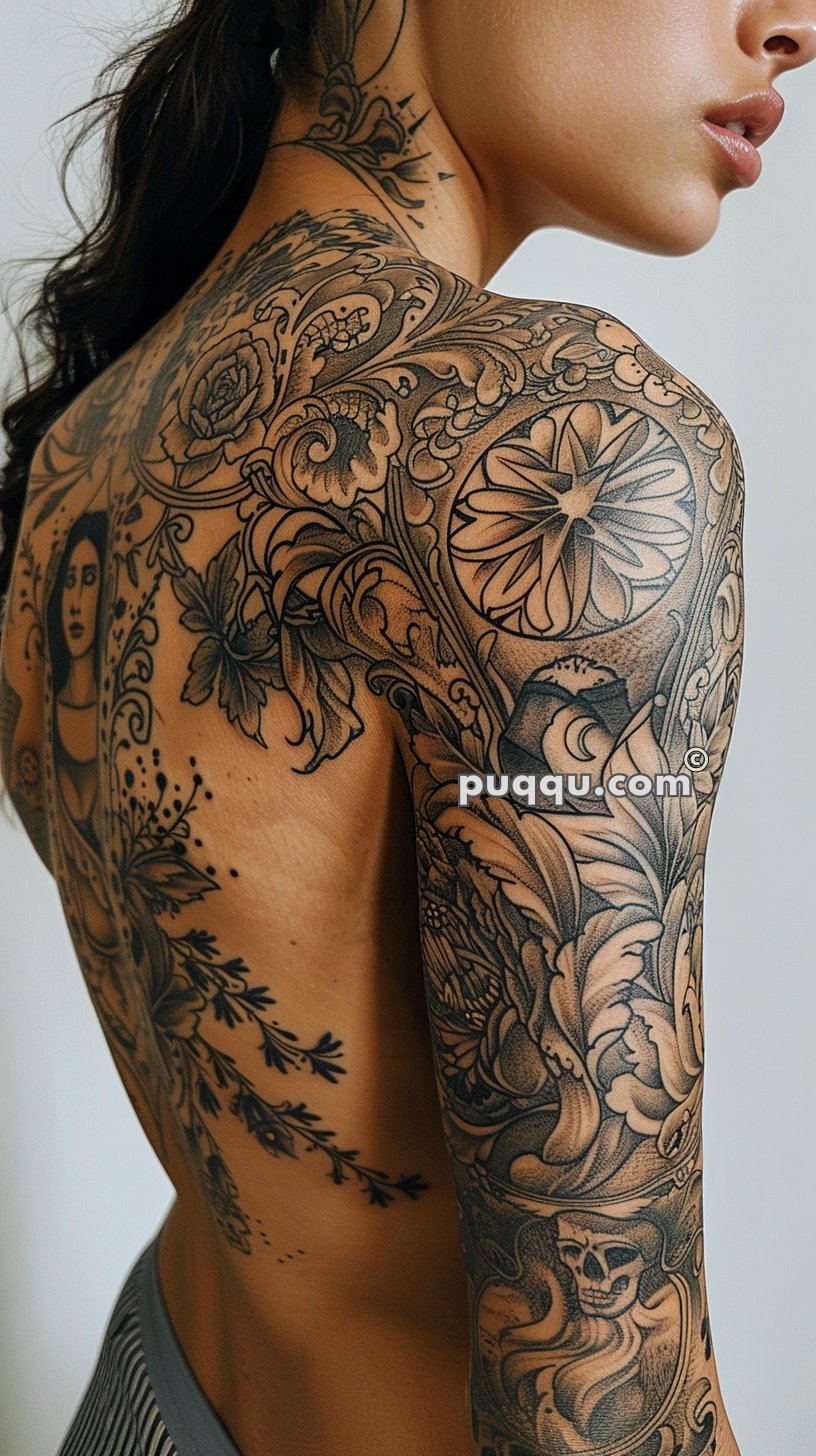 Person with elaborate black and grey tattoos covering their shoulder, upper back, and upper arm, depicting floral, geometric, and portrait designs.