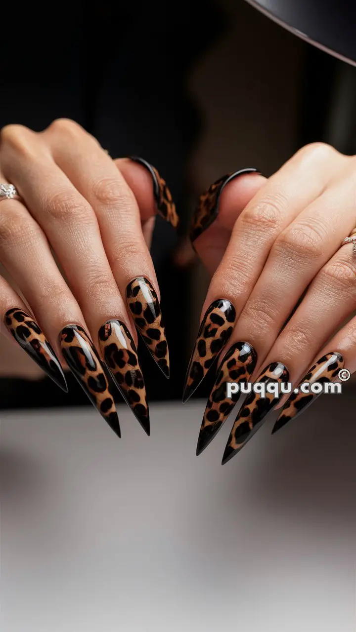 Hands with long, sharp nails featuring a leopard print design.