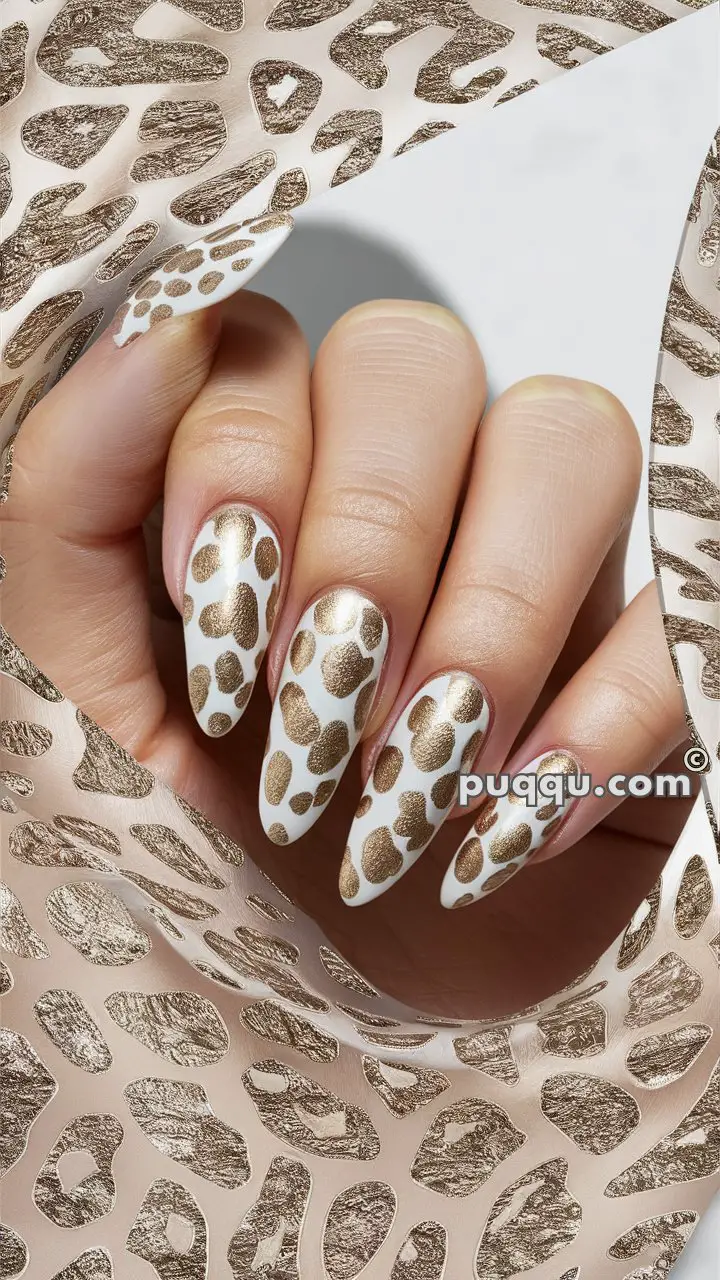 Close-up of a hand with long, manicured nails featuring a white background and gold leopard print design.