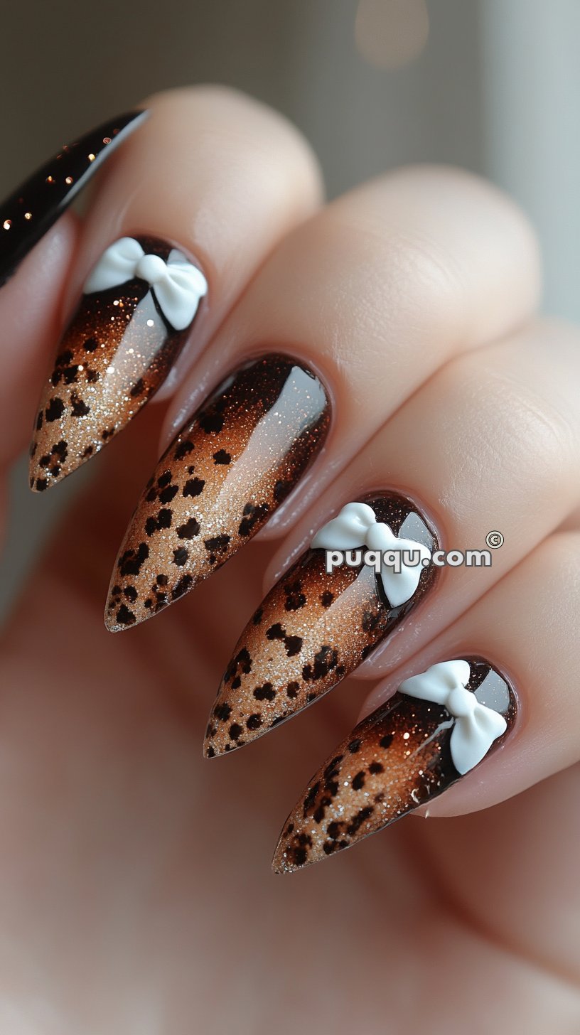 Close-up of stiletto-shaped nails with leopard print and glitter gradient design, accentuated by white bow decorations.