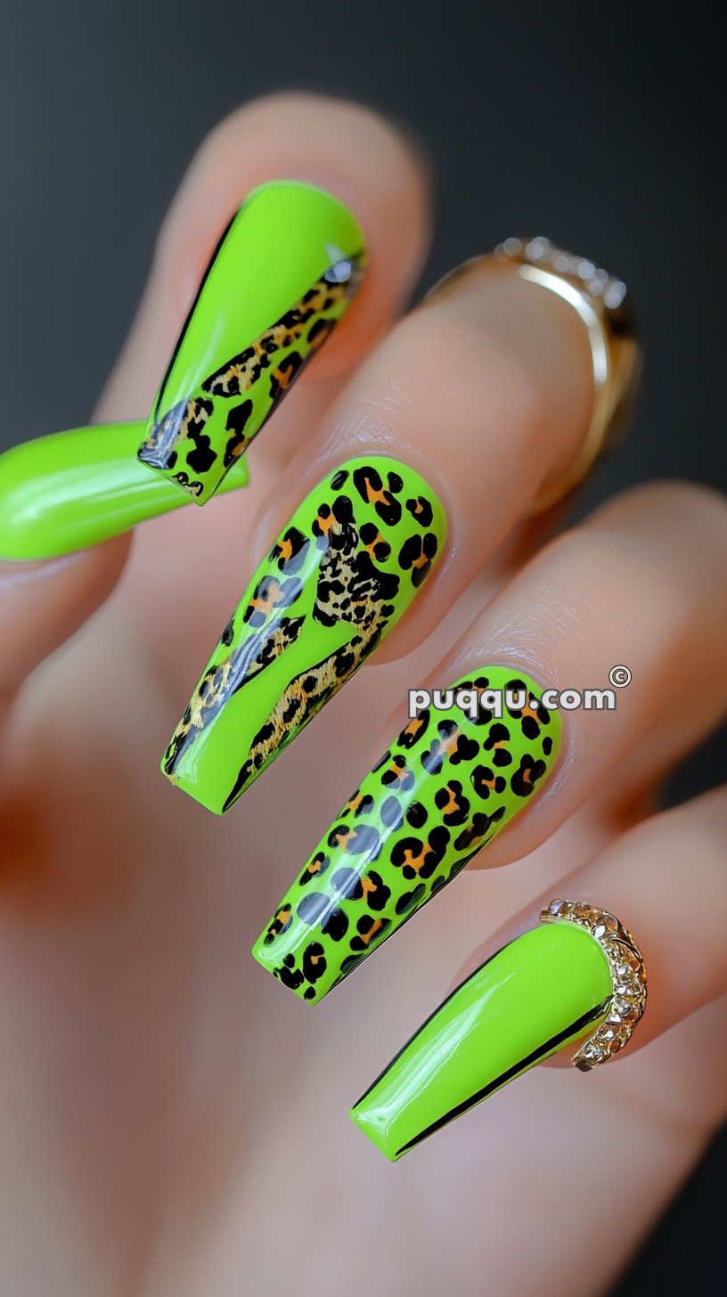 Long neon green nails with black leopard print design and a single nail featuring a gold rhinestone accent at the cuticle.