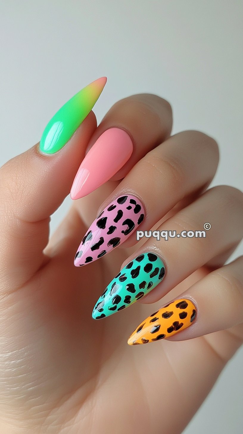 Colorful stiletto nails with a gradient green and yellow, solid pink, and leopard print designs on pink, green, and orange backgrounds.