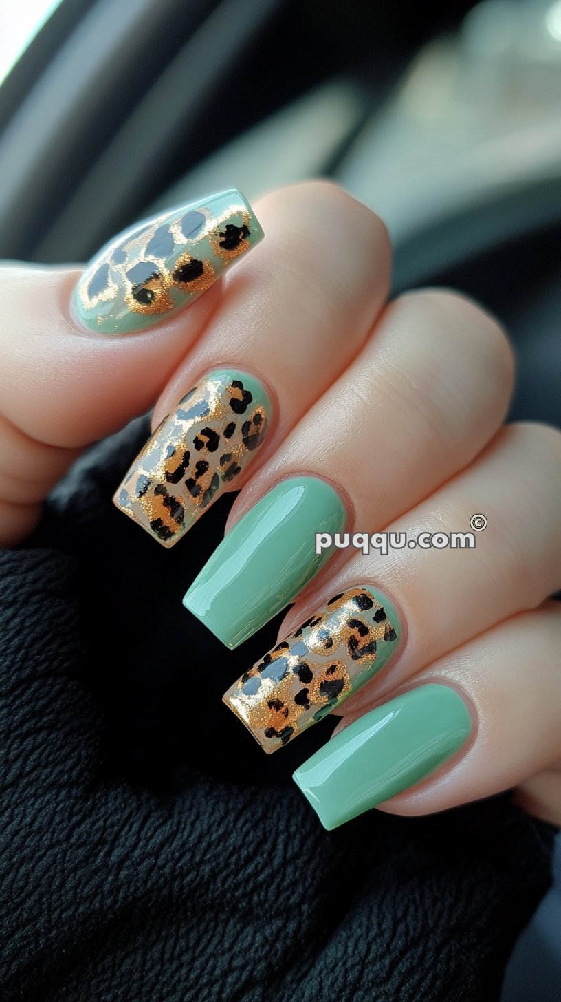 Green and gold leopard print nail art on long, square-shaped nails.