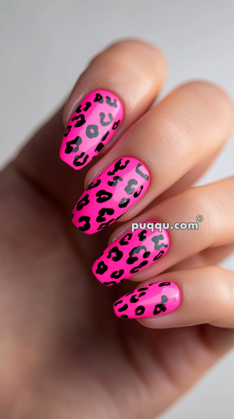 Pink nails with black leopard print design.