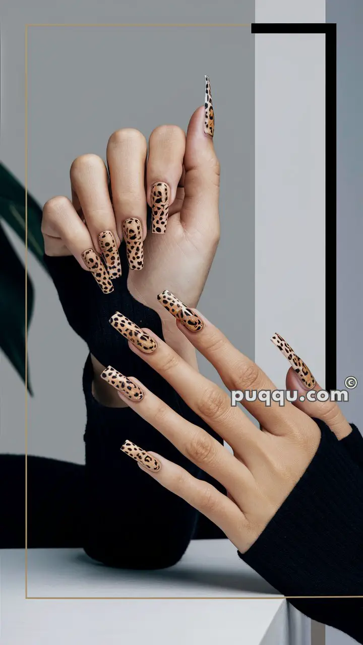 Hands with long nails featuring leopard print nail art.