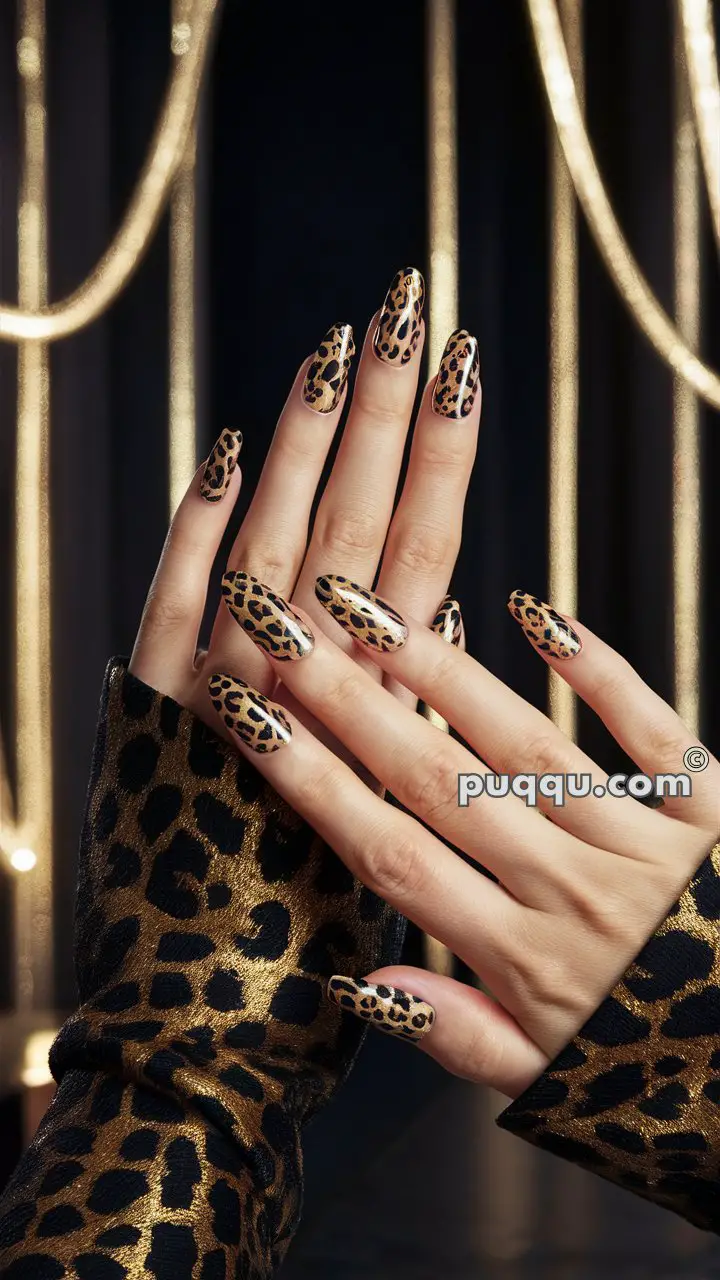 Hands with long nails painted in a leopard print design, wearing a matching leopard print outfit.