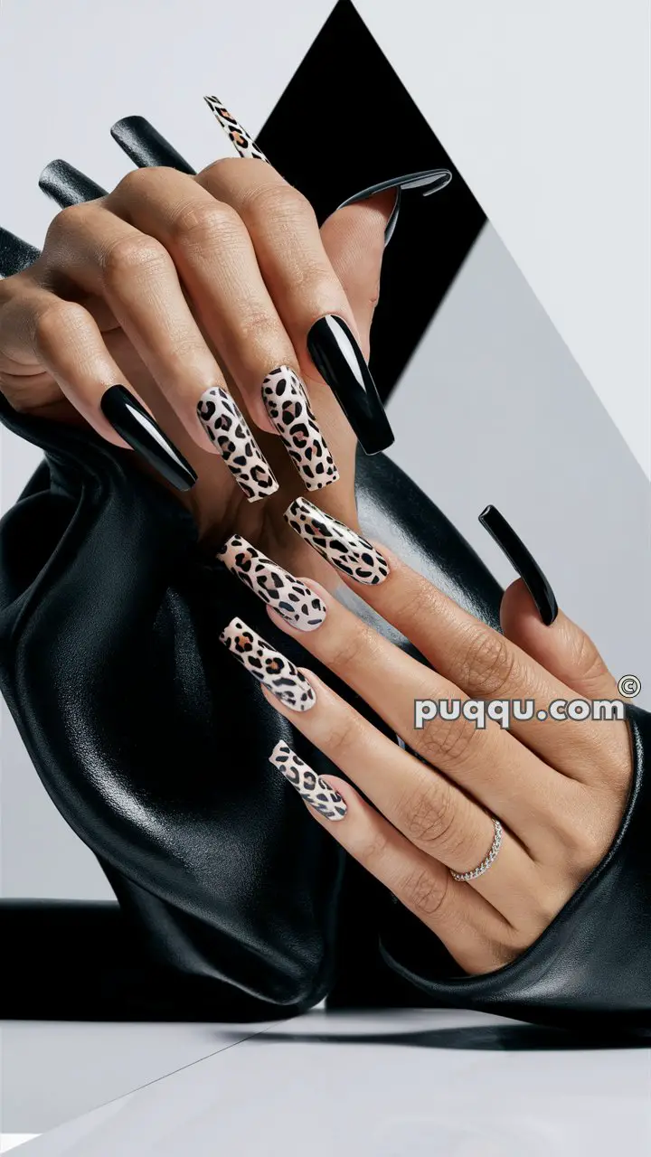 Close-up of hands with long black and leopard print nails against a geometric black and white background.