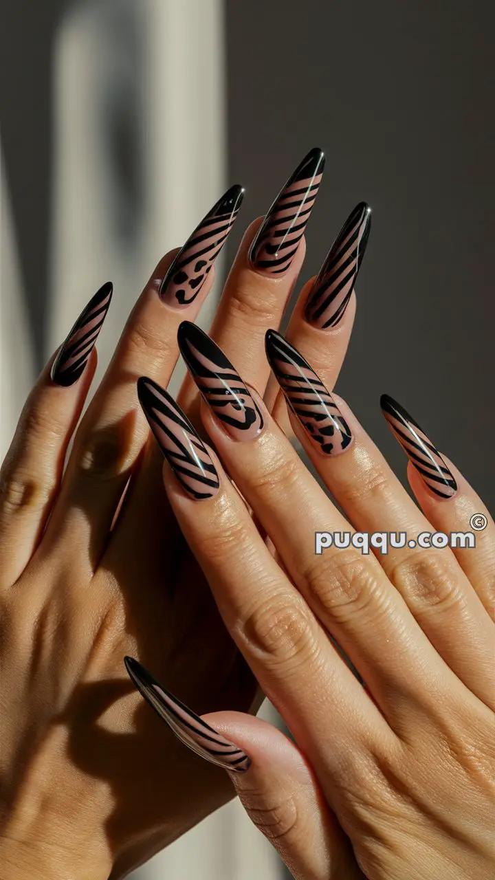 Hands with long, almond-shaped nails featuring a black and nude animal print design.