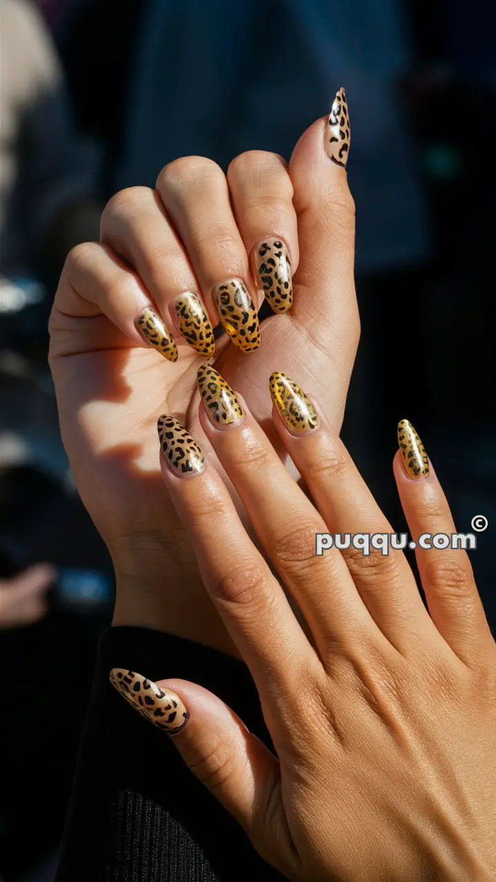 Close-up of hands with long nails featuring leopard print nail art.