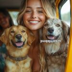 Smiling woman in a colorful setting sitting between two dogs inside a vehicle.