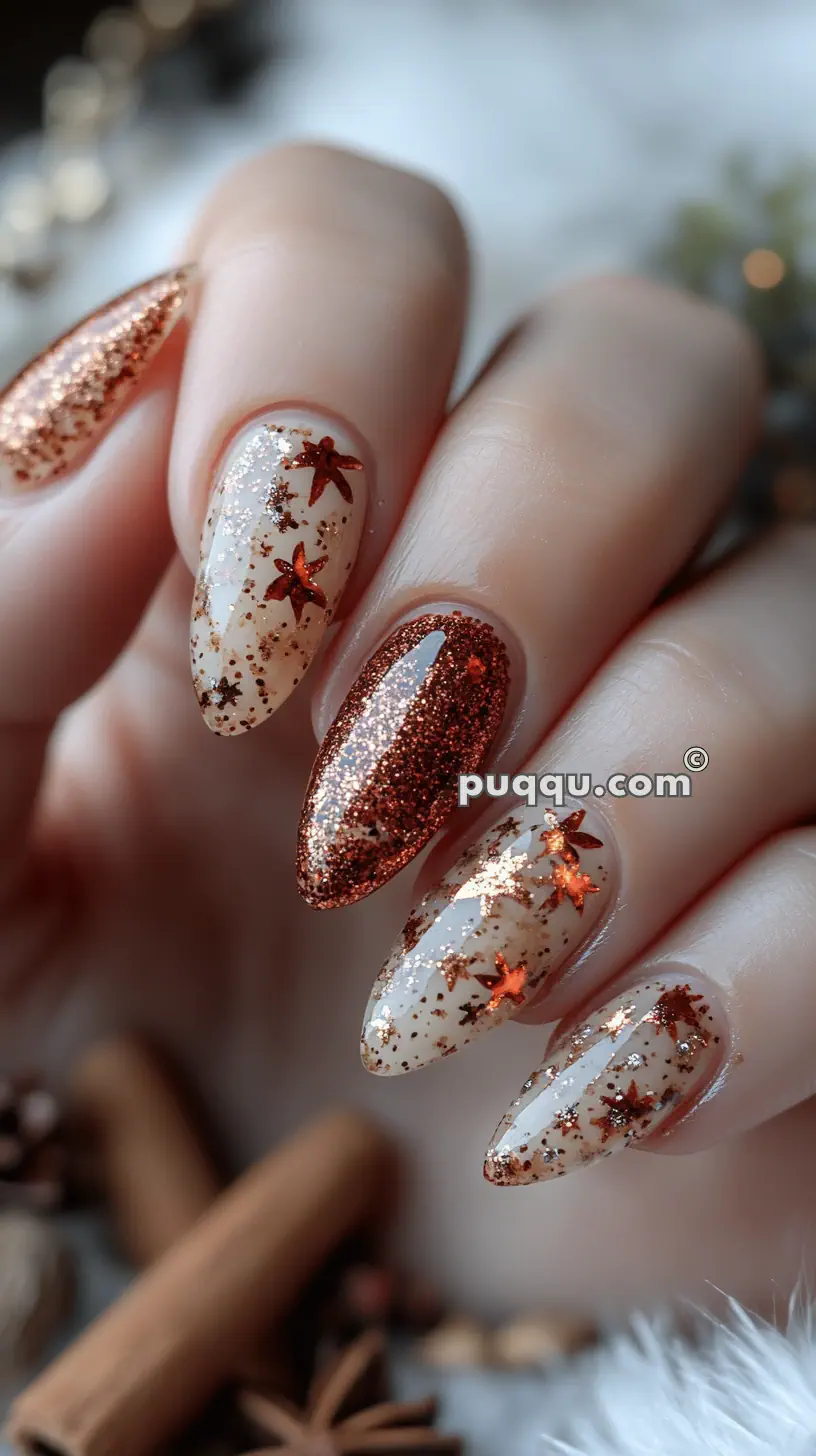 Hand with almond-shaped nails featuring glittery red and gold star decorations.