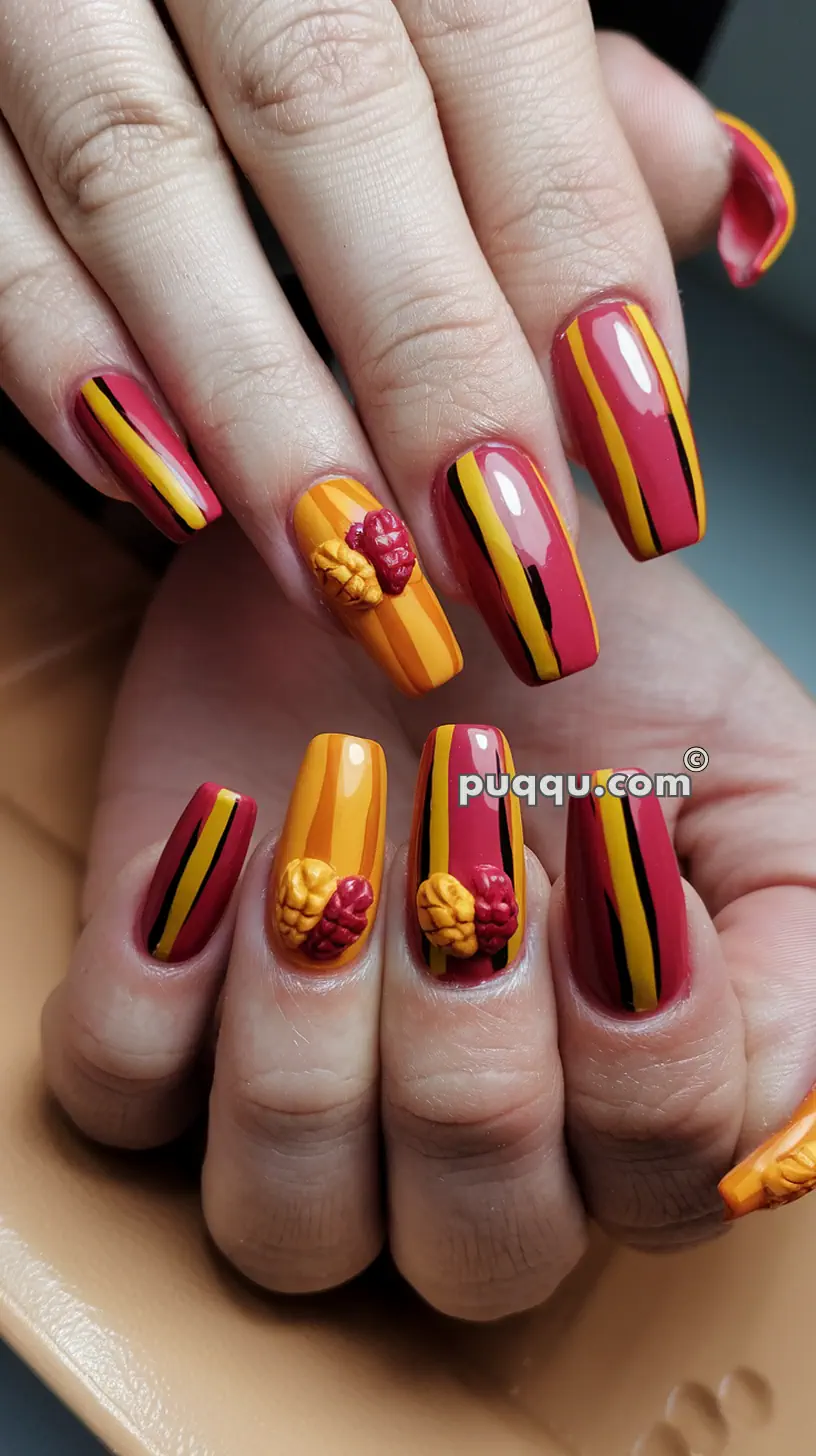 Nails with striped design in red, yellow, and black, some featuring 3D floral artwork.