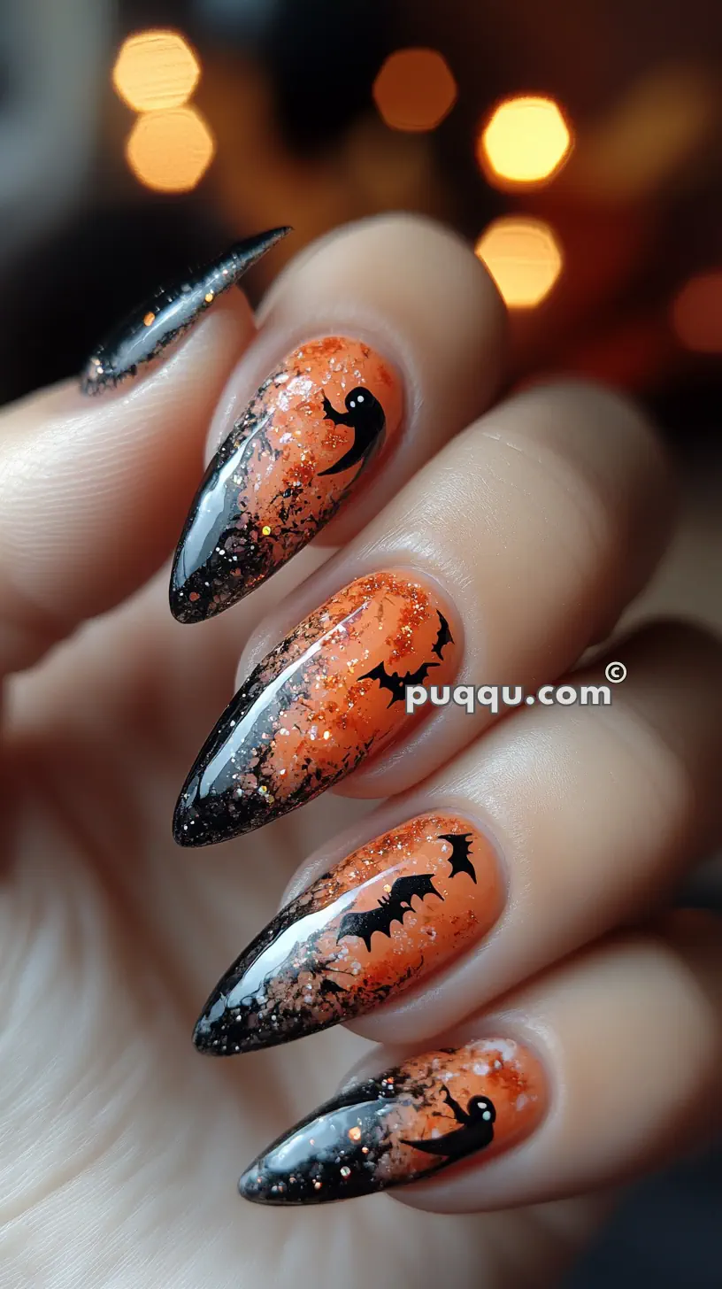 Halloween-themed nail art with long almond-shaped nails featuring an orange and black gradient, black bats, and a ghost design.