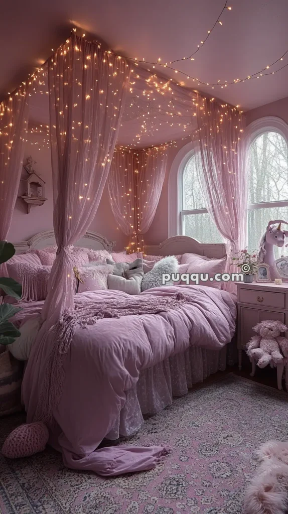 A cozy bedroom with pink decor featuring a canopy bed draped in sheer pink fabric and illuminated by fairy lights, with a fluffy rug, plush toys, and large windows letting in natural light.