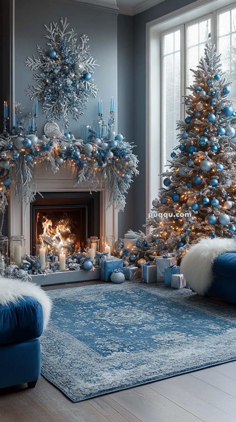 A cozy living room decorated for Christmas in blue and silver, featuring a Christmas tree, a lit fireplace, candles, and presents.