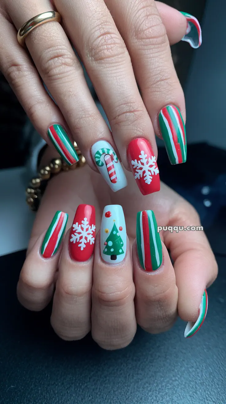 Fingernails with festive Christmas designs, including candy canes, snowflakes, a Christmas tree, and red, green, and white stripes.