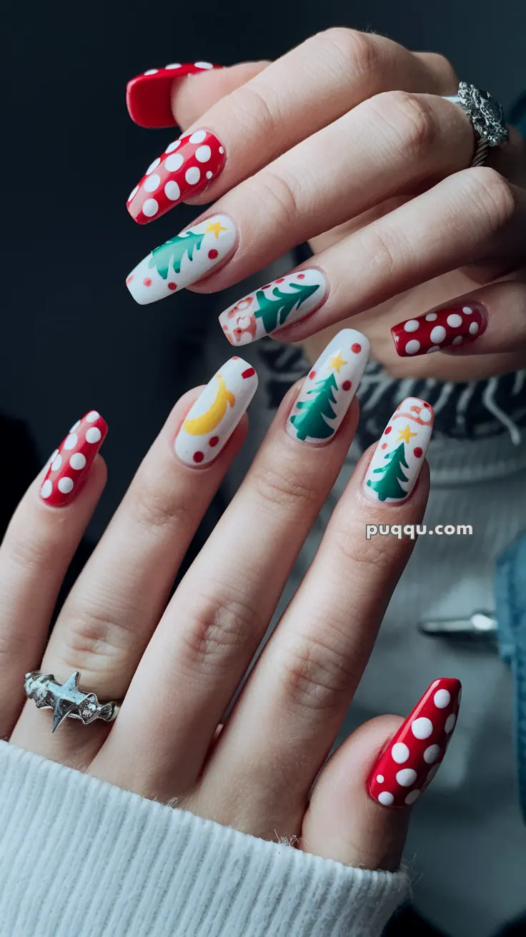 Close-up of hands with Christmas-themed nail art featuring red and white polka dots, Christmas trees, stars, and ornaments.