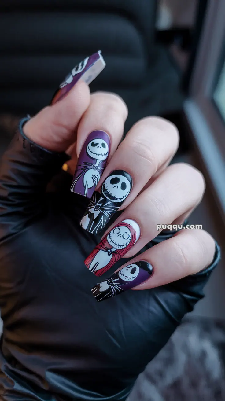 Halloween-themed nail art featuring cartoon skeleton designs on long nails, with a gloved hand.