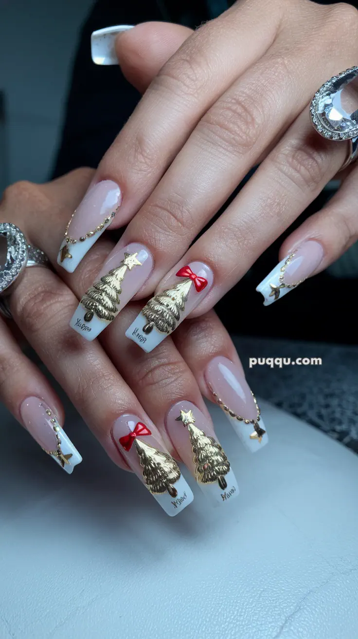 Nails with festive designs featuring gold Christmas trees, red bows, and small star embellishments.