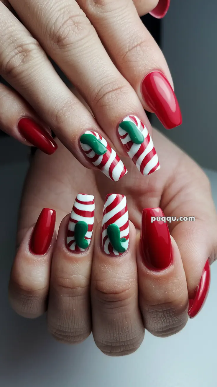 Red and white striped candy cane nails with green leaf accents and solid red nails.