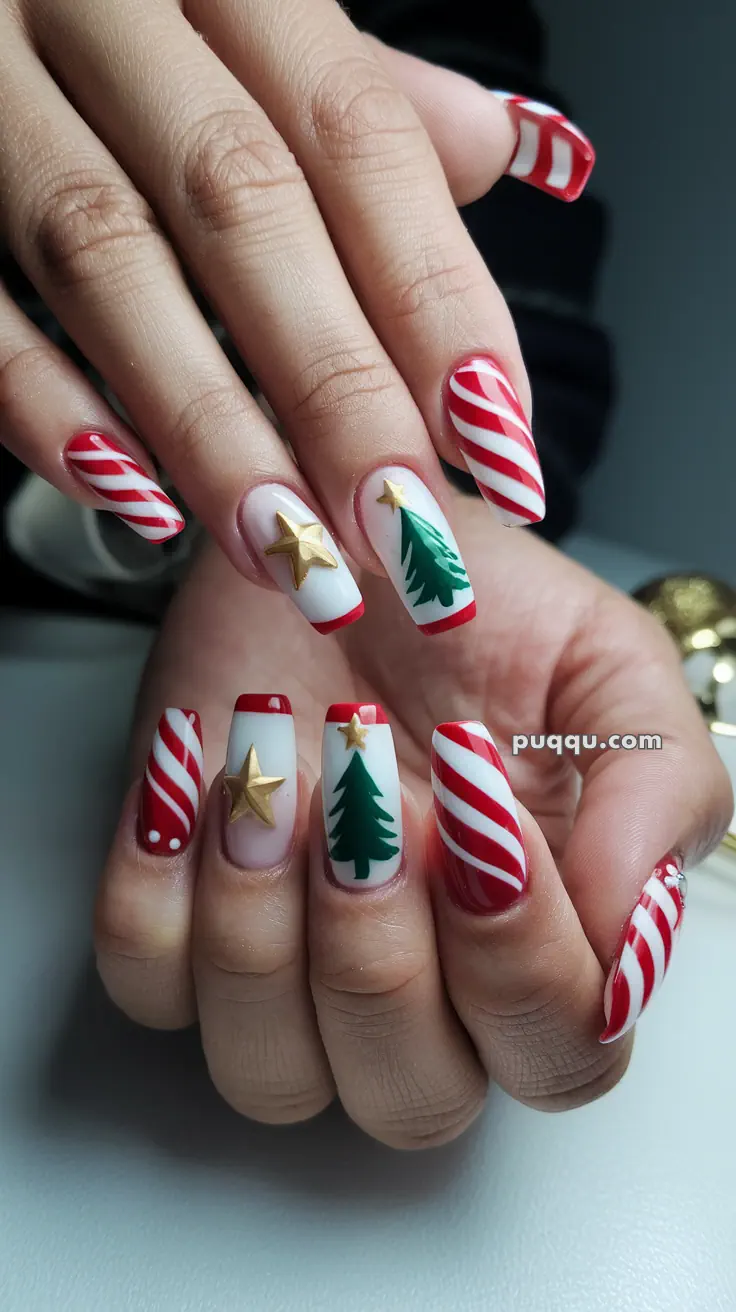 Fingernails with festive designs, featuring red and white stripes, gold stars, and green Christmas trees.