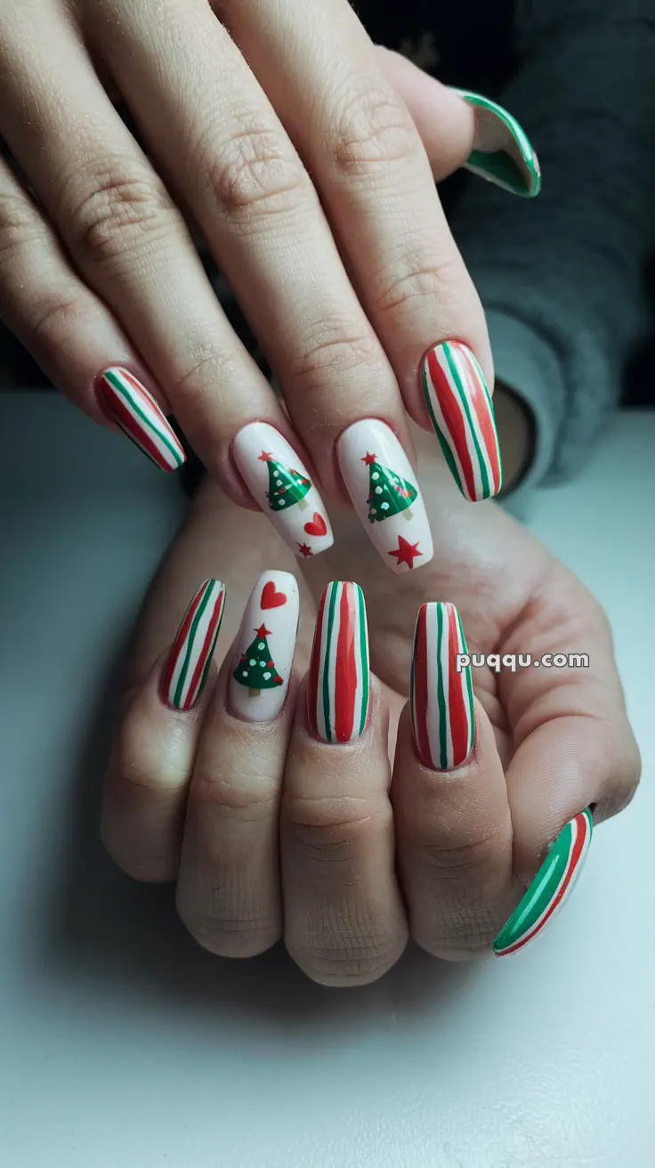 Christmas-themed nail art with red, green, and white stripes, decorated with Christmas trees, hearts, and stars.