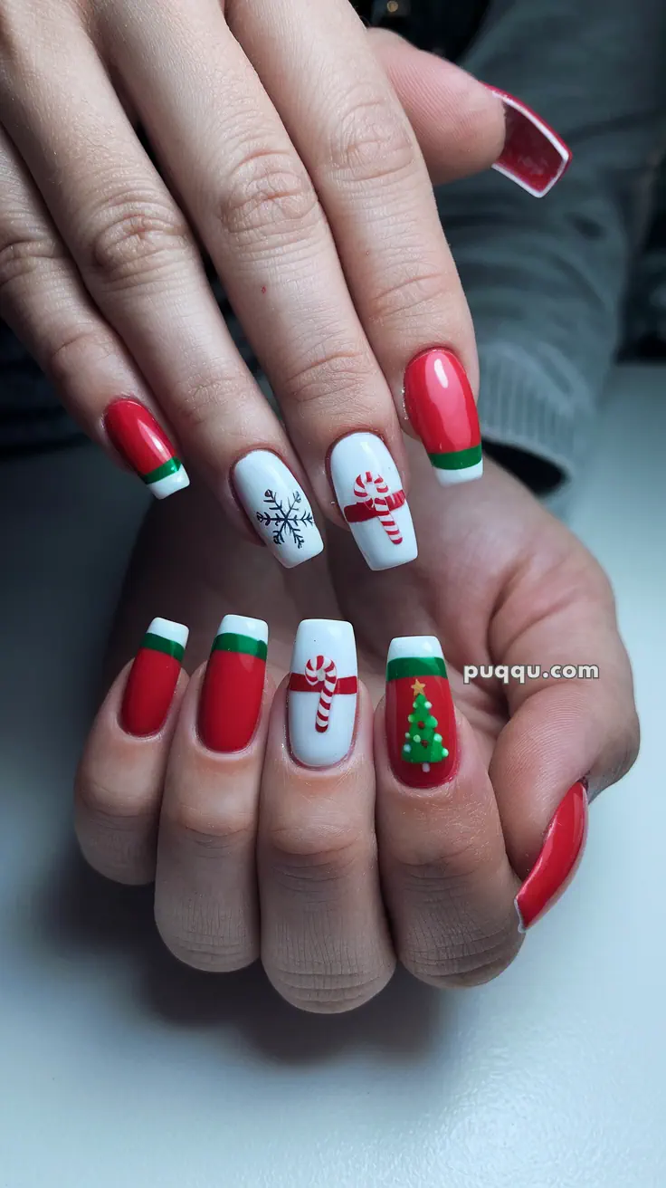 Festive Christmas-themed nail art with red and white colors, featuring candy canes, snowflakes, and Christmas tree designs.