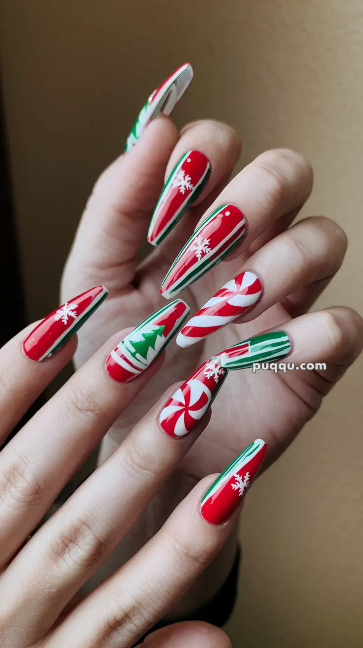 Festive Christmas-themed nail art with red, white, and green designs, featuring snowflakes, candy cane stripes, and a Christmas tree.