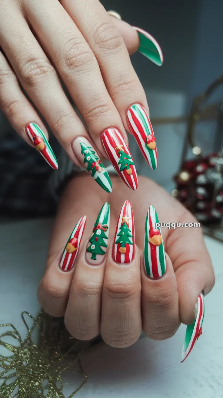 Festive Christmas-themed nail art with red, white, and green stripes, adorned with 3D Christmas trees and ornaments.