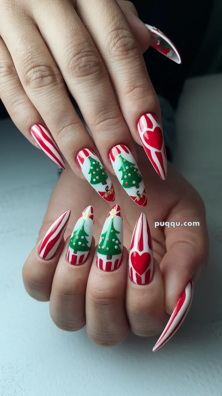 Long nails with Christmas-themed nail art featuring red and white stripes, Christmas trees, and hearts.