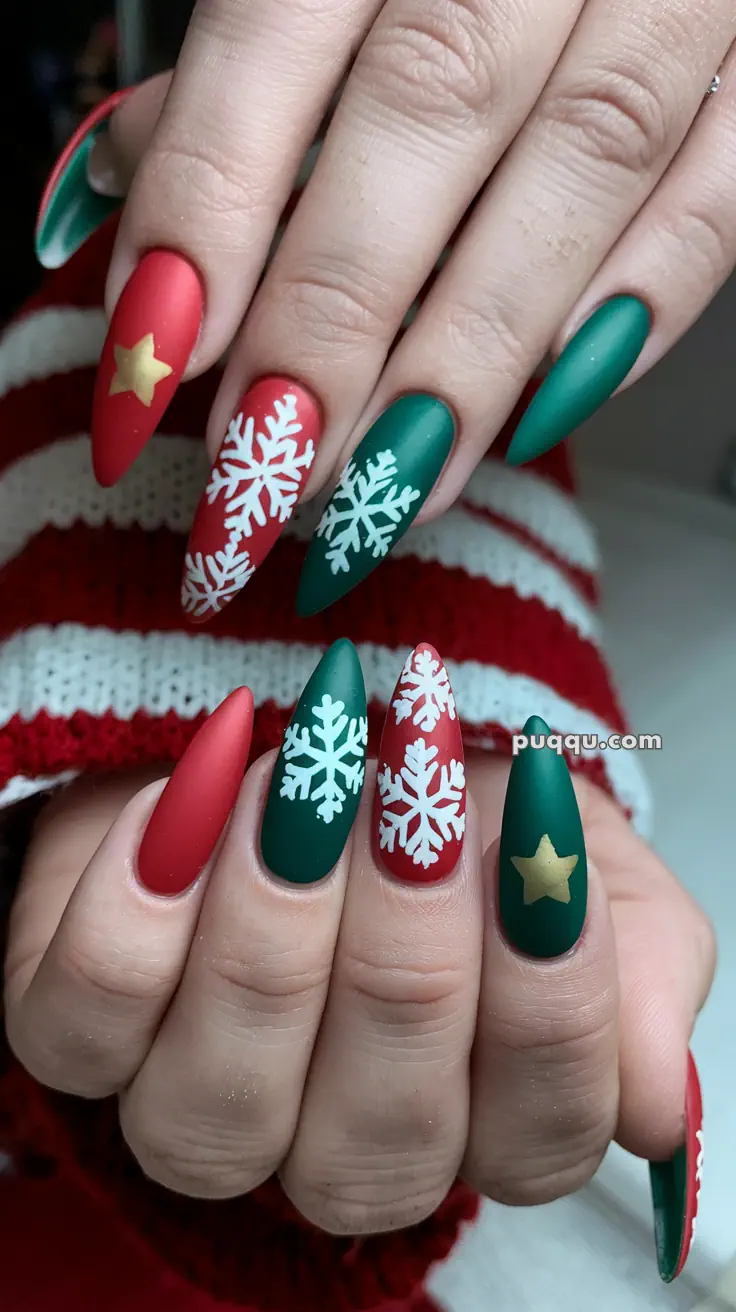 Festive nail art with red and green matte polish, featuring snowflake designs and gold stars.