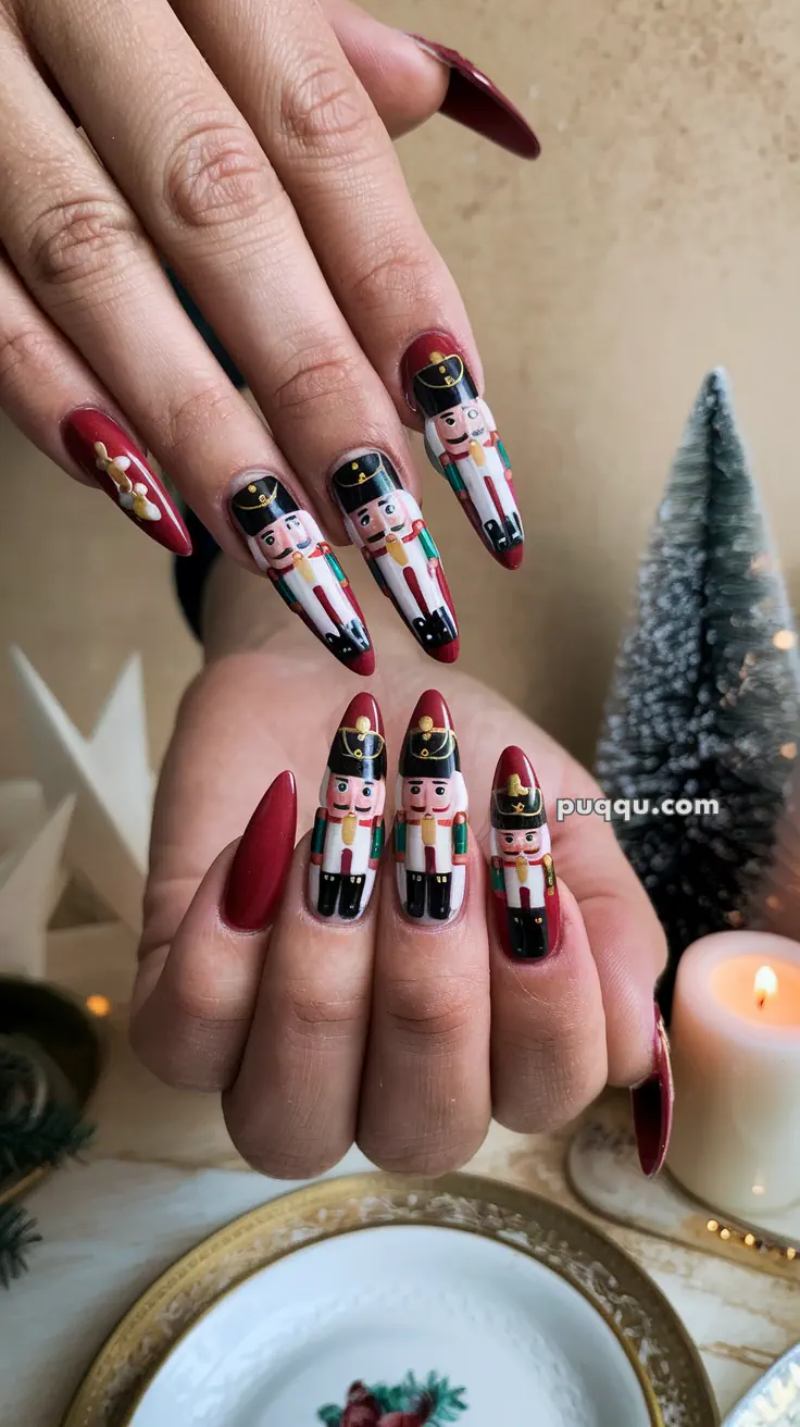 Close-up of hands with red nails featuring nutcracker designs, set against a festive background with a small pine tree and a lit candle.