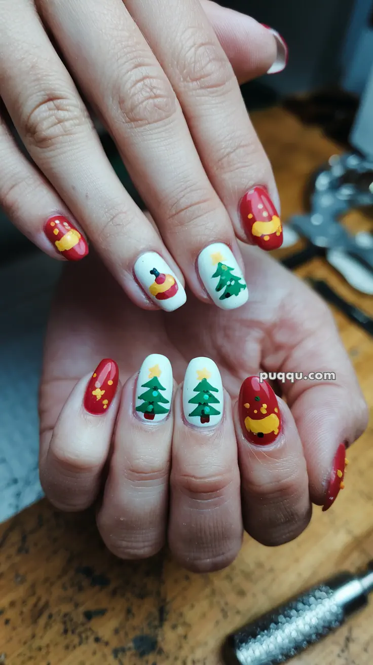 Fingernails decorated with Christmas-themed nail art, featuring red and white backgrounds with designs of Christmas trees and ornaments.