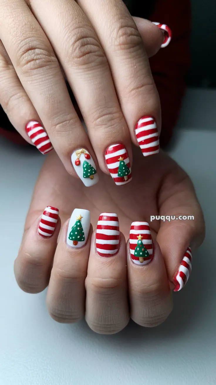 Fingernails with red and white striped nail art and Christmas tree designs.