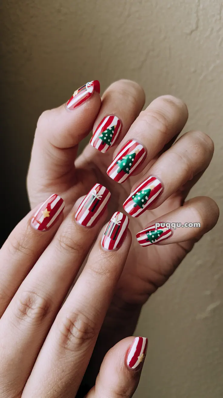 Fingernails with red and white stripes, featuring Christmas tree and star designs.