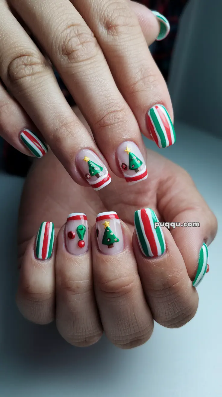 Christmas-themed nail art with stripes and 3D decorations of Christmas trees and holly.