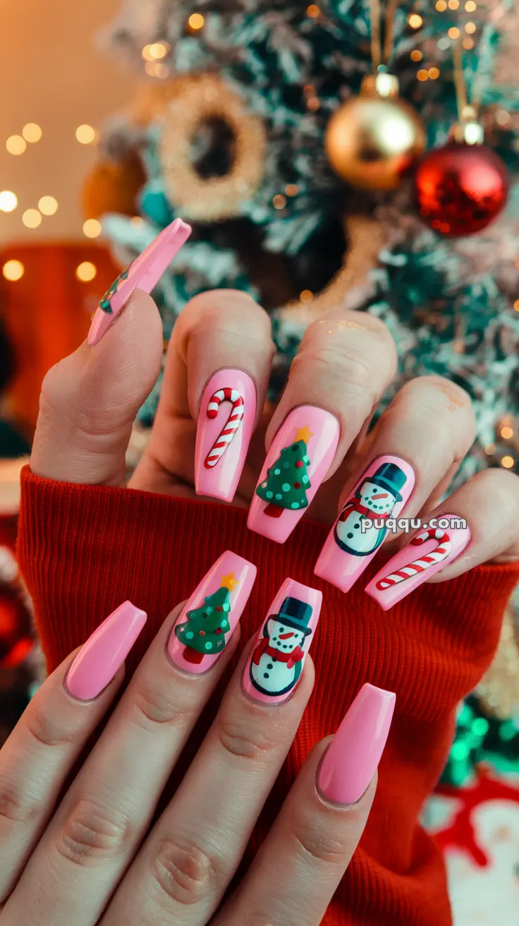 Pink Christmas-themed nail art featuring candy canes, Christmas trees, and snowmen, with a festive background.