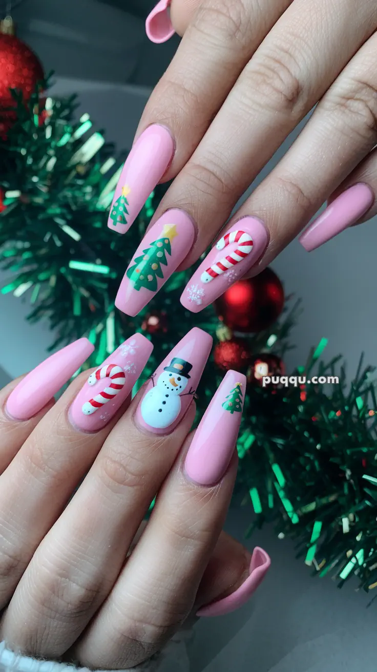 Pink Christmas-themed nail art with designs of trees, candy canes, and a snowman.