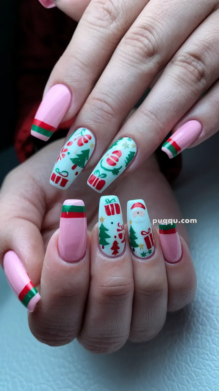 Festive Christmas-themed nail art with pink base, featuring designs of Santa, presents, candy canes, and Christmas trees.