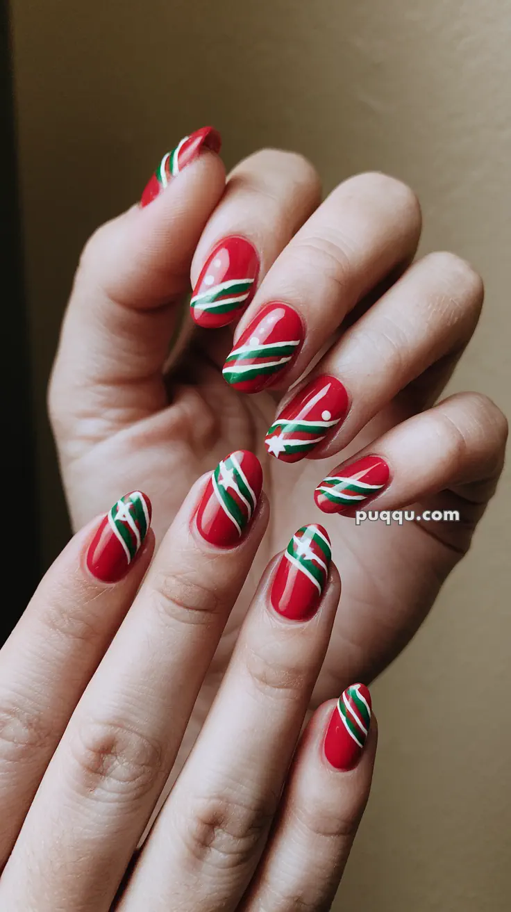 Red nails with white and green swirl designs.